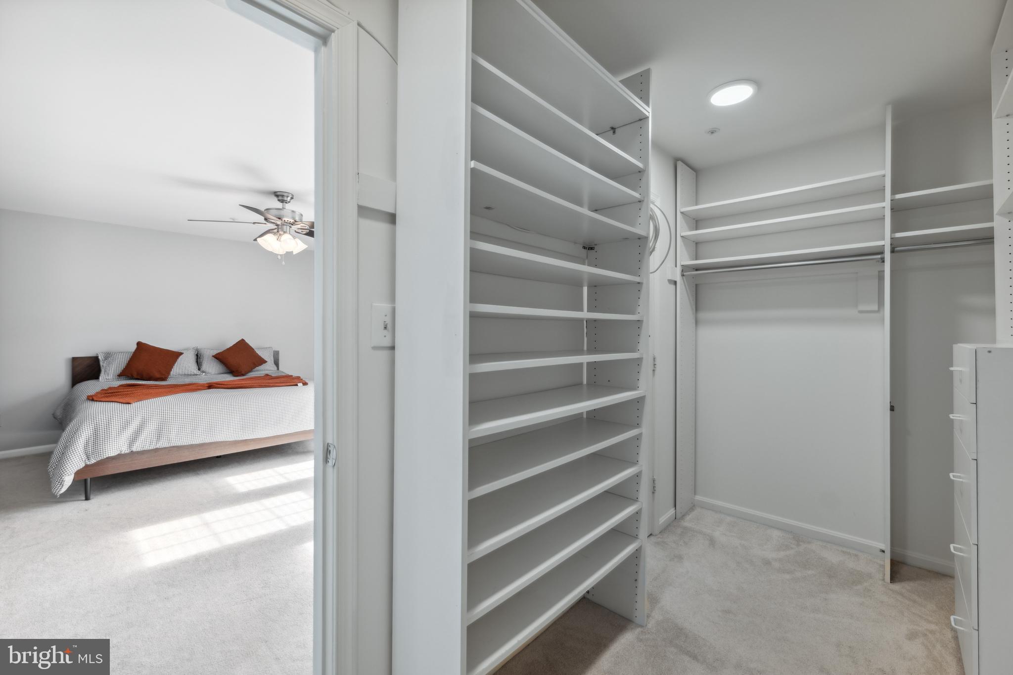 6934F Ellingham Circle Alexandria, VA 22315 - Photo 16 of 34 a bedroom with a bed and a cabinets