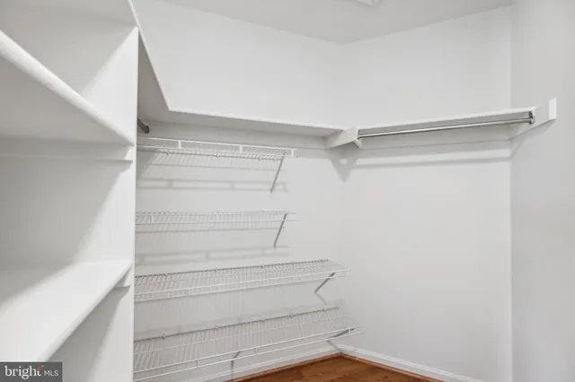 a view of walk in closet with empty racks