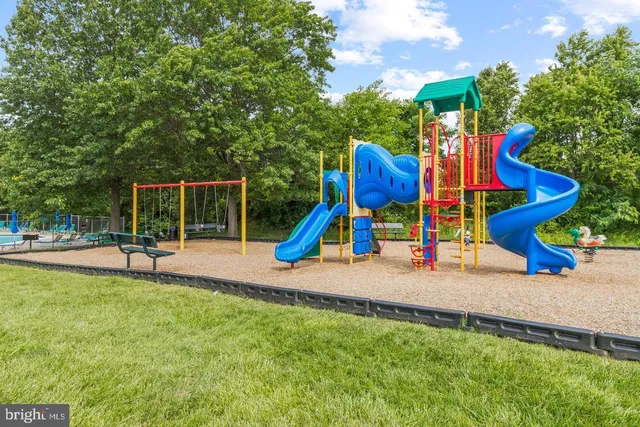 a view of park with slide and bench