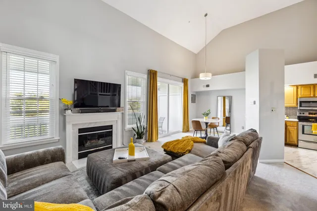 a living room with furniture flat screen tv and a fireplace