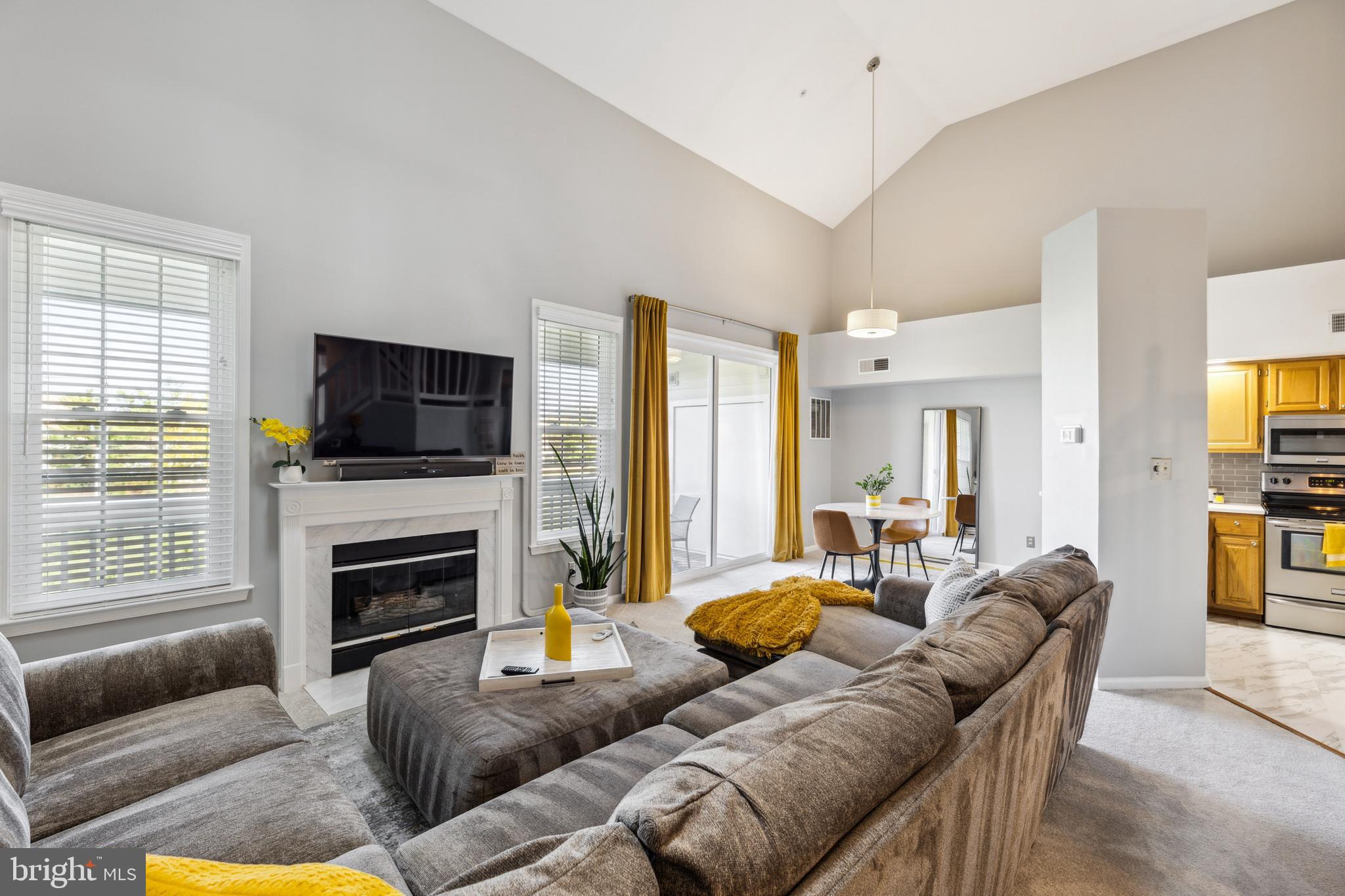 6934F Ellingham Circle Alexandria, VA 22315 - Photo 4 of 34 a living room with furniture flat screen tv and a fireplace