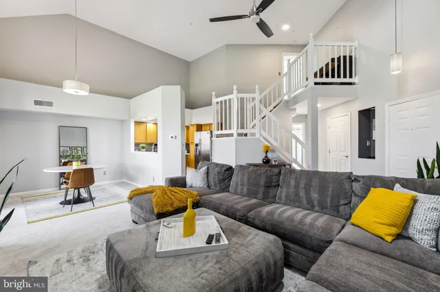 a living room with furniture and a lamp