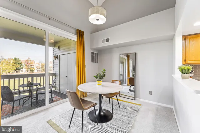 a view of a dining room with furniture and window