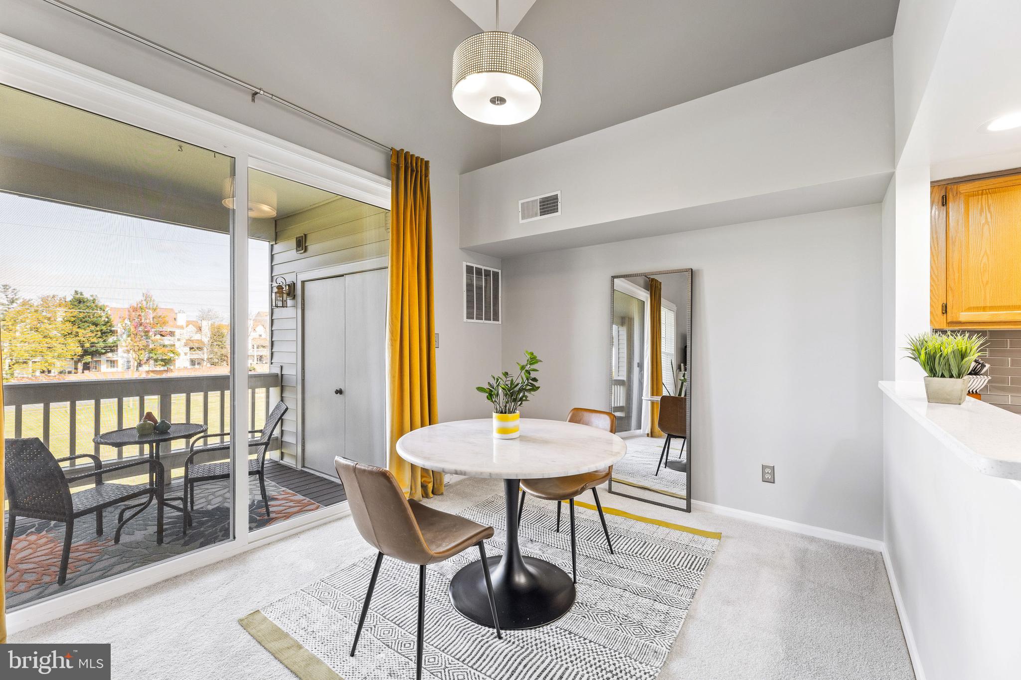 6934F Ellingham Circle Alexandria, VA 22315 - Photo 7 of 34 a view of a dining room with furniture and window