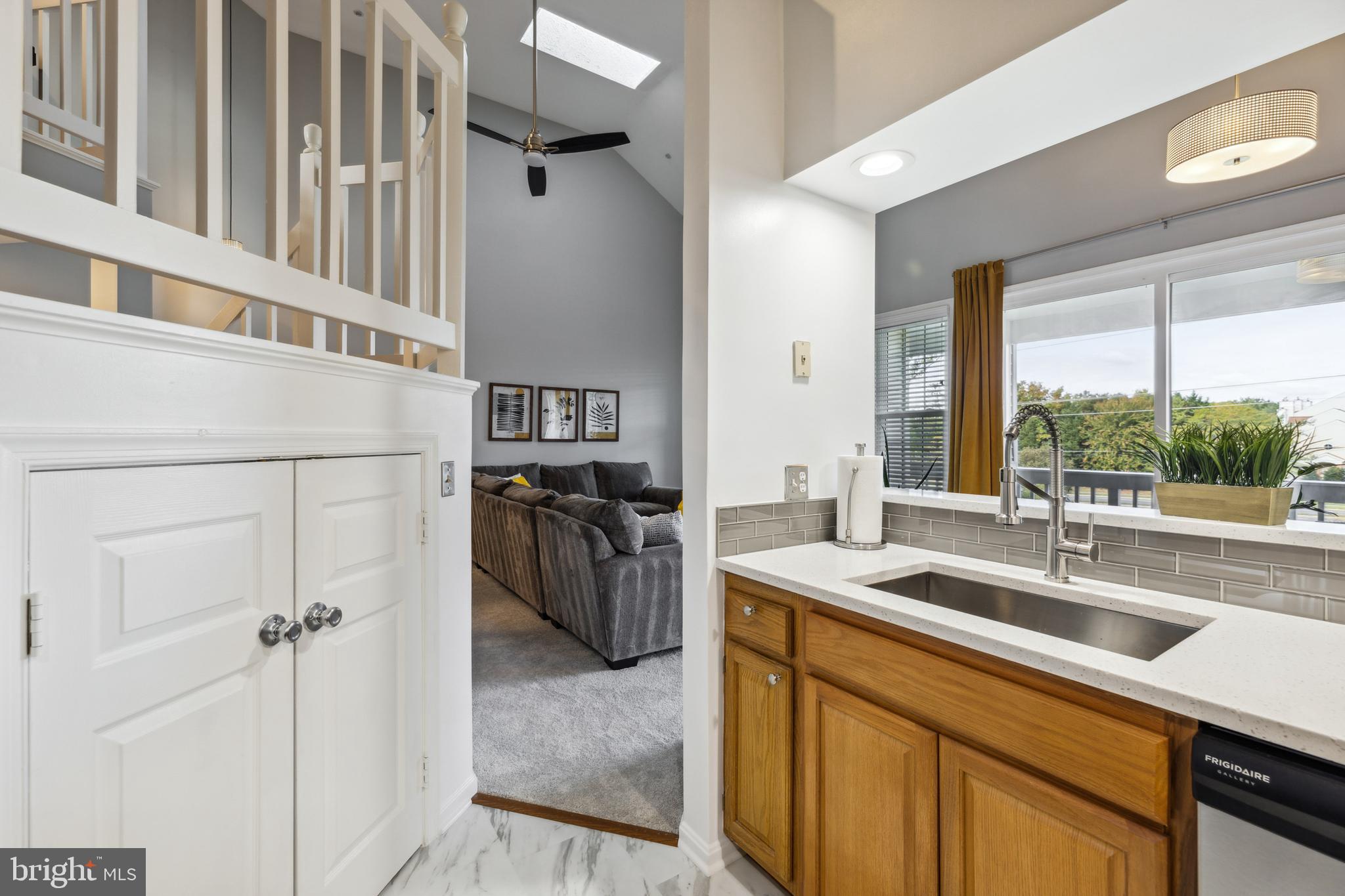 6934F Ellingham Circle Alexandria, VA 22315 - Photo 10 of 34 a kitchen with a sink appliances cabinets and a large window