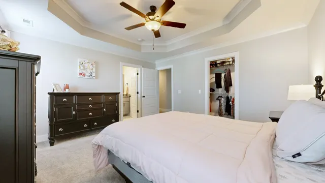 a bedroom with a bed and a dresser