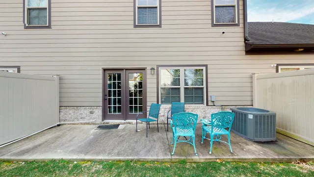 a view of a chair and table in backyard of the house