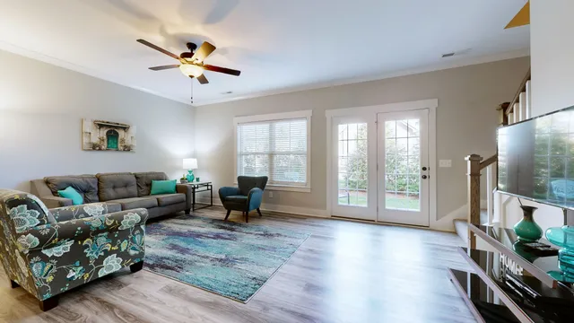 a view of a workspace with furniture and wooden floor