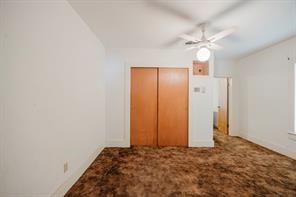 1717 Pipeline Road Cleburne, TX 76033 - Photo 7 of 33 Unfurnished bedroom featuring dark carpet, a closet, and a ceiling fan