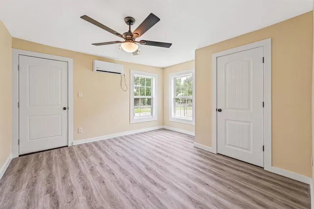 a view of a livingroom with a hardwood floor and a ceiling fan