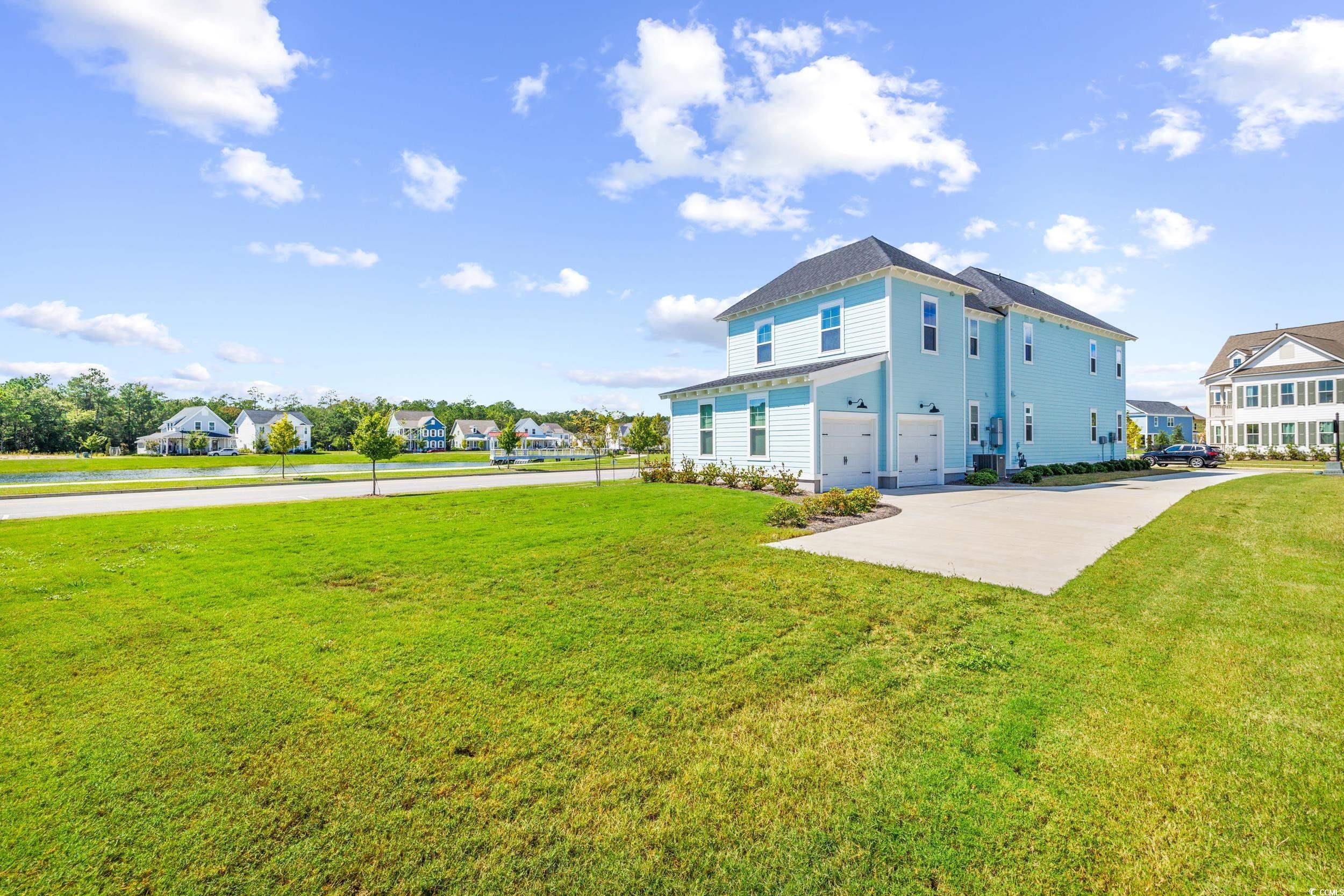 Back of house featuring a lawn