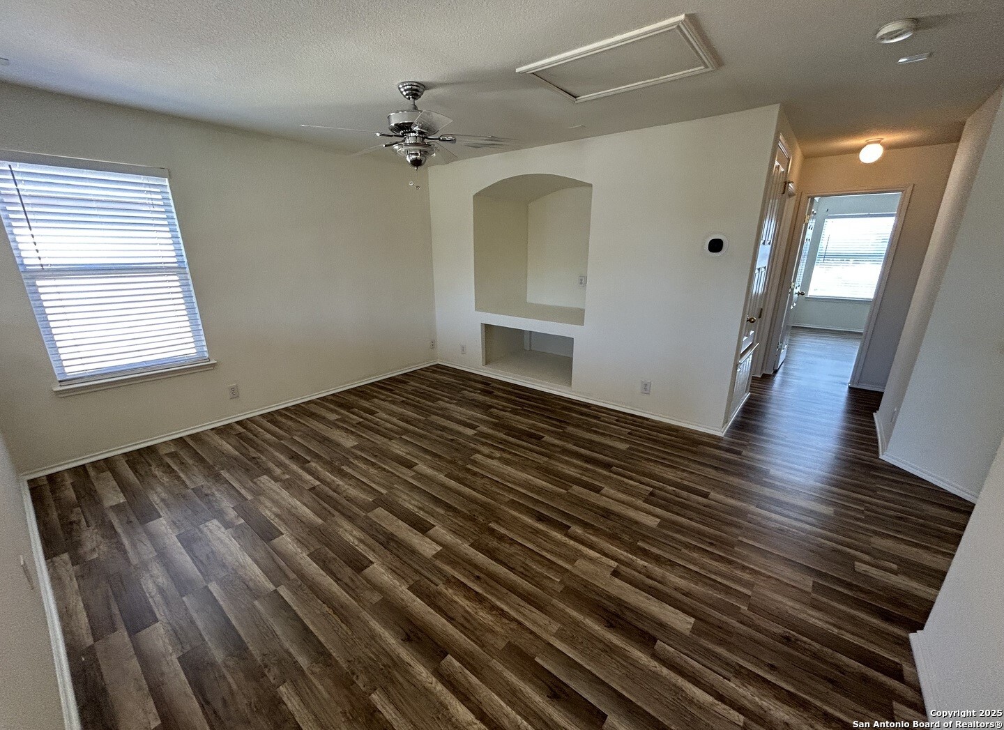 7714 Cold Mountain Converse, TX 78109 - Photo 14 of 27 a view of an empty room with wooden floor and a window