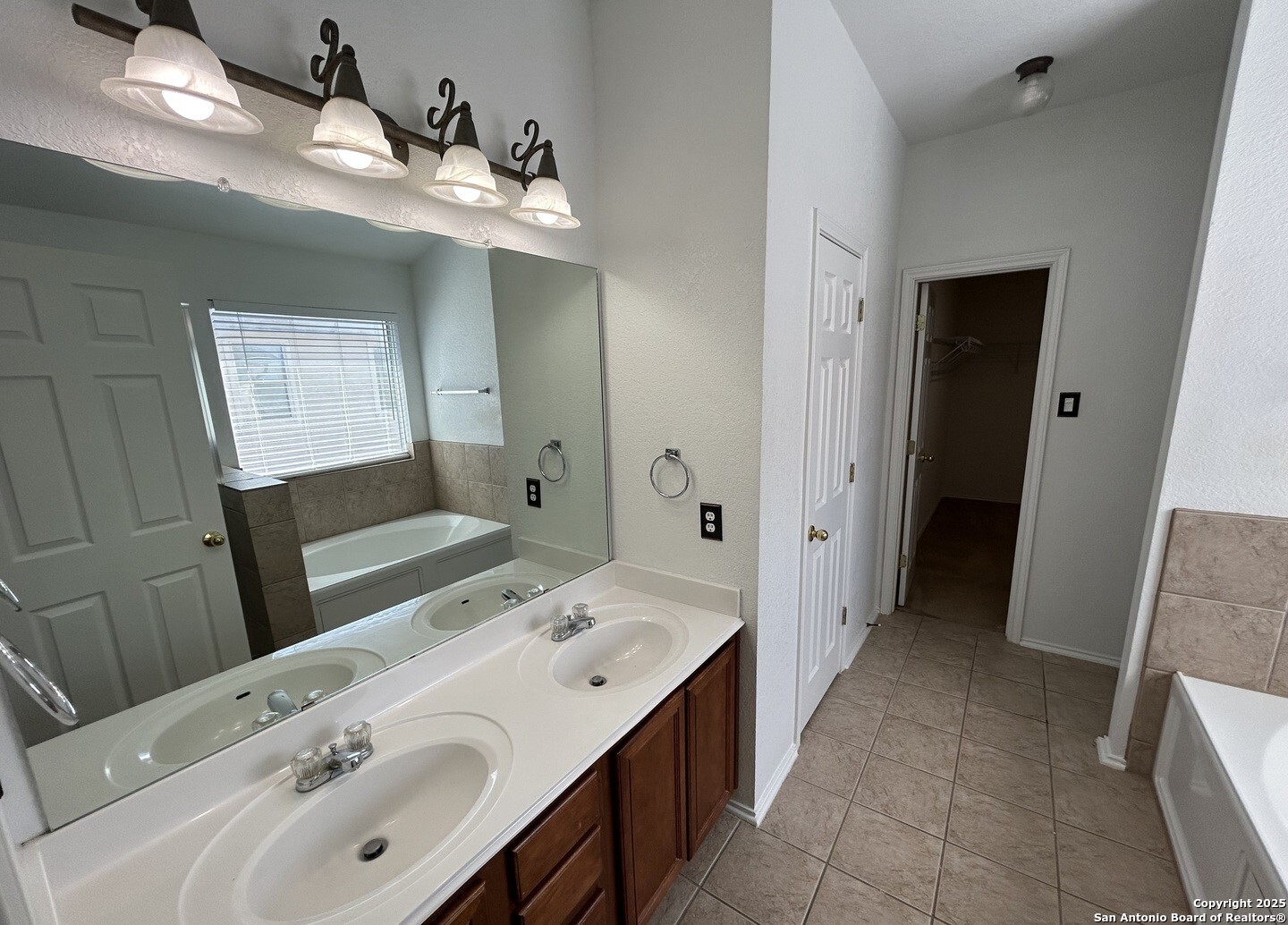 7714 Cold Mountain Converse, TX 78109 - Photo 19 of 27 a bathroom with a double vanity sink and mirror