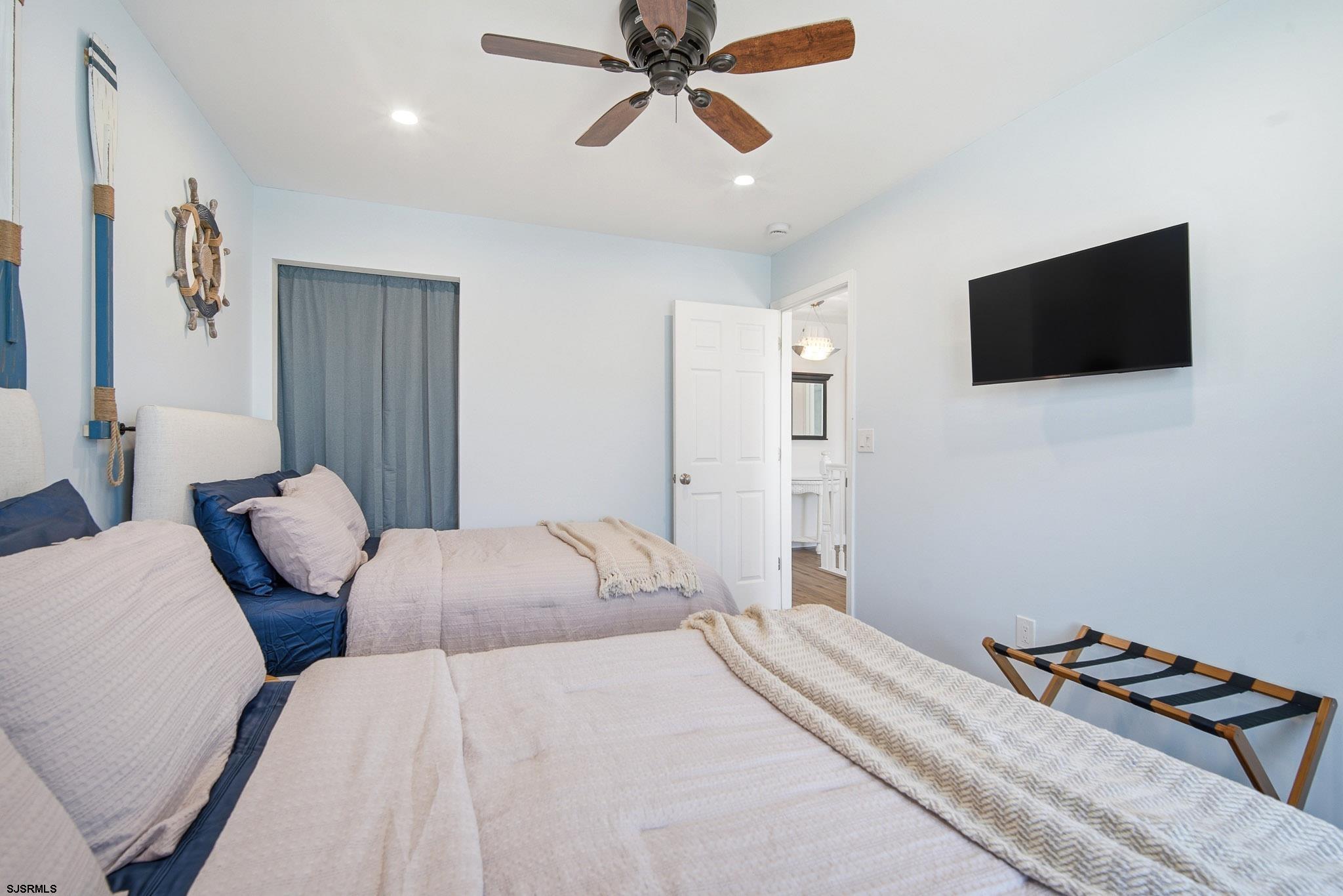 214 Hagen Road Brigantine, NJ 08203 - Photo 17 of 34 a bedroom with a bed and a flat screen tv