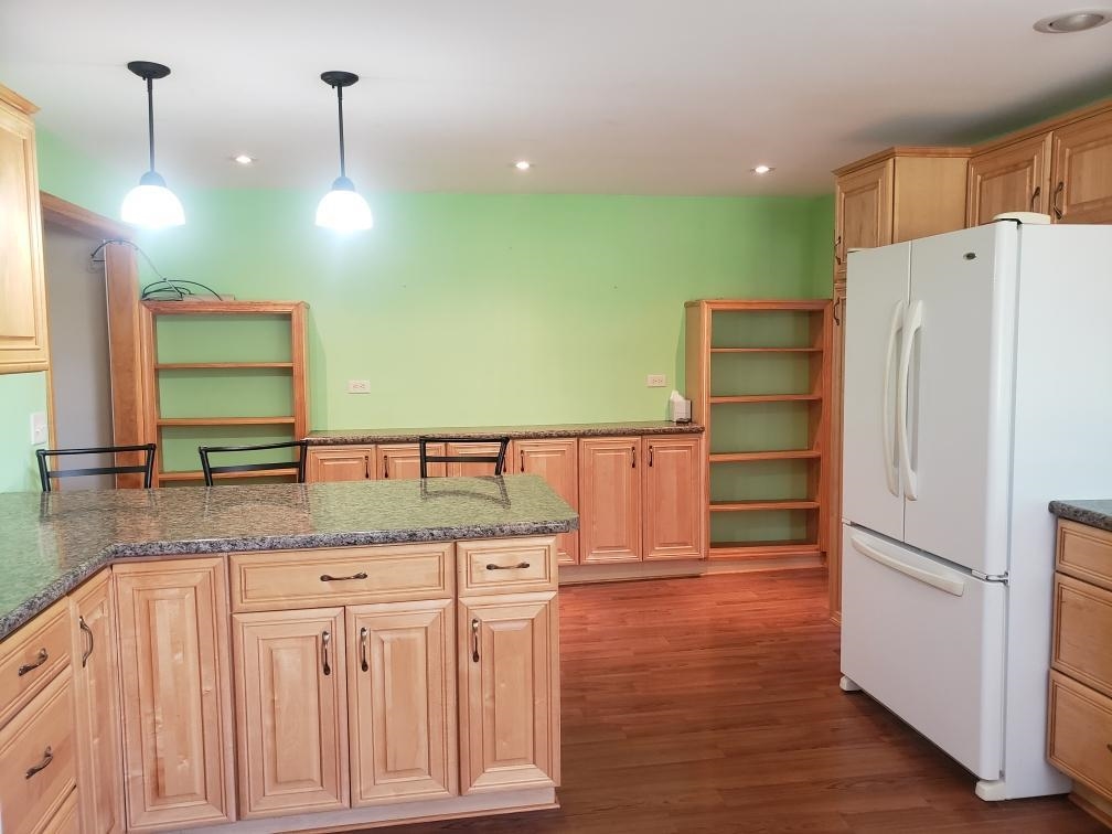 603 East Currier Road Freeport, IL 61032 - Photo 12 of 24 a kitchen with stainless steel appliances granite countertop a refrigerator a sink and a stove