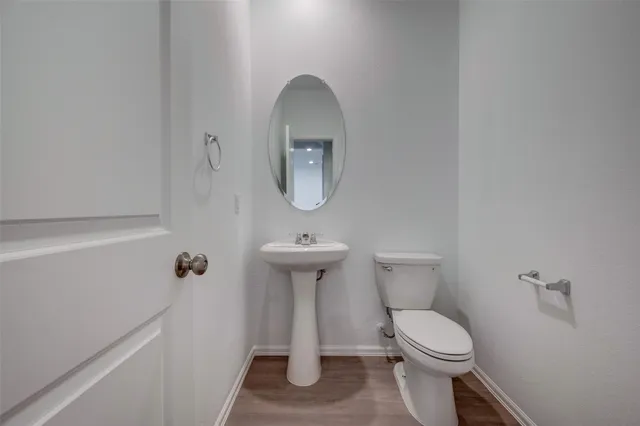 a bathroom with a double vanity sink and a toilet