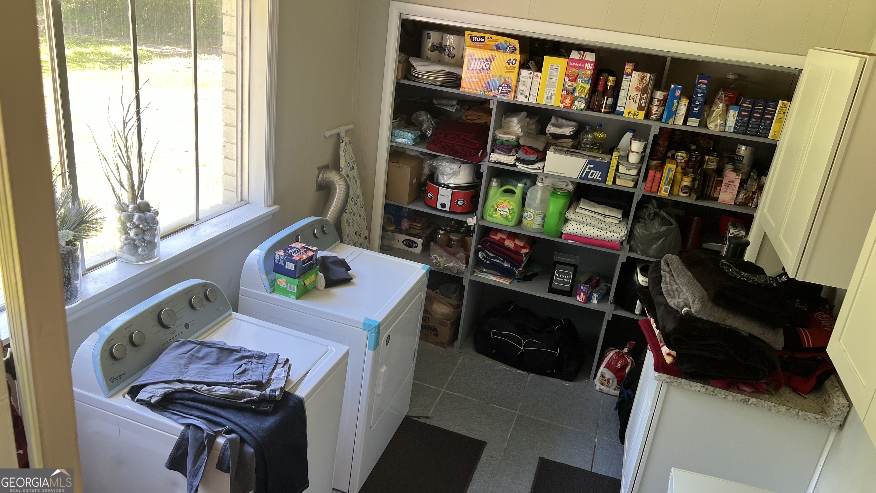 1065 Nathan Jones Road Harlem, GA 30814 - Photo 28 of 32 a room with furniture a bookshelf and a window
