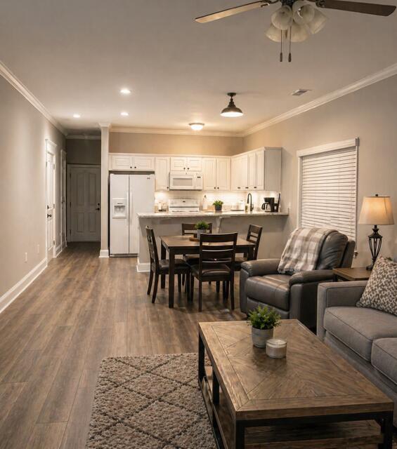 1722 Kenwood Road Manning, SC 29102 - Photo 3 of 15 Step inside to a spacious family room with fireplace that opens to the dining area and kitchen, creating an inviting open-concept layout perfect for everyday living and entertaining.