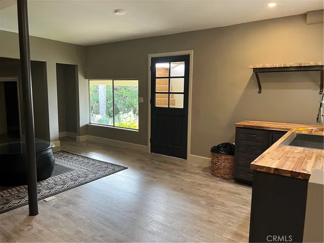 a view of a balcony with chair and wooden floor