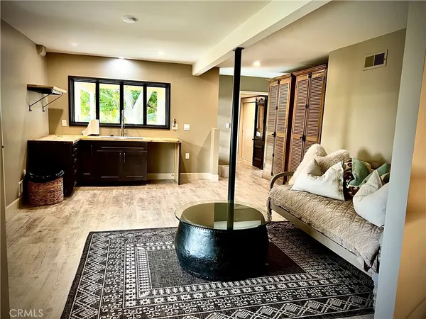 a bedroom with a bed and painting on the wall
