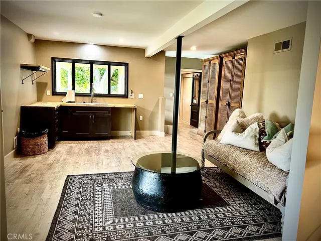 a bedroom with a bed and painting on the wall