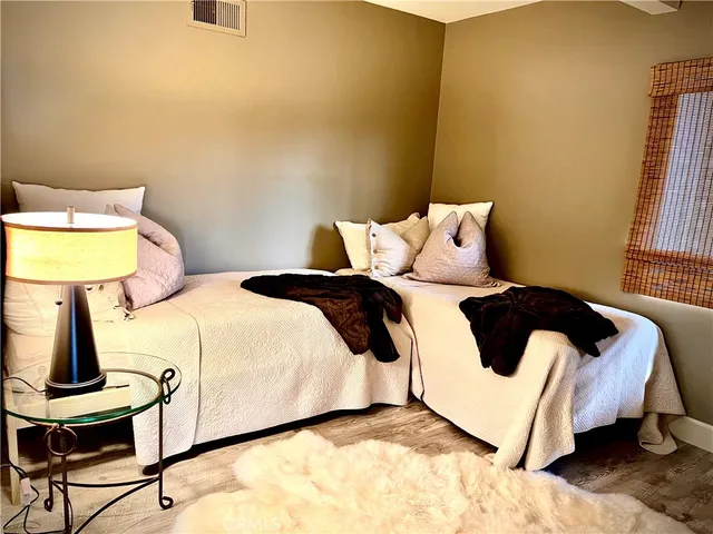 a bed sitting in a bedroom next to a window