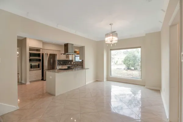 a open kitchen with white cabinets and stainless steel appliances