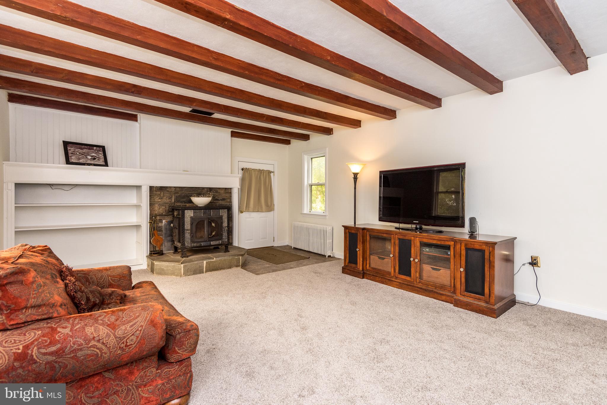 218 North Ridge Road Perkasie, PA 18944 - Photo 4 of 28 Living Room w/ Wood Burning Stove And Shelves