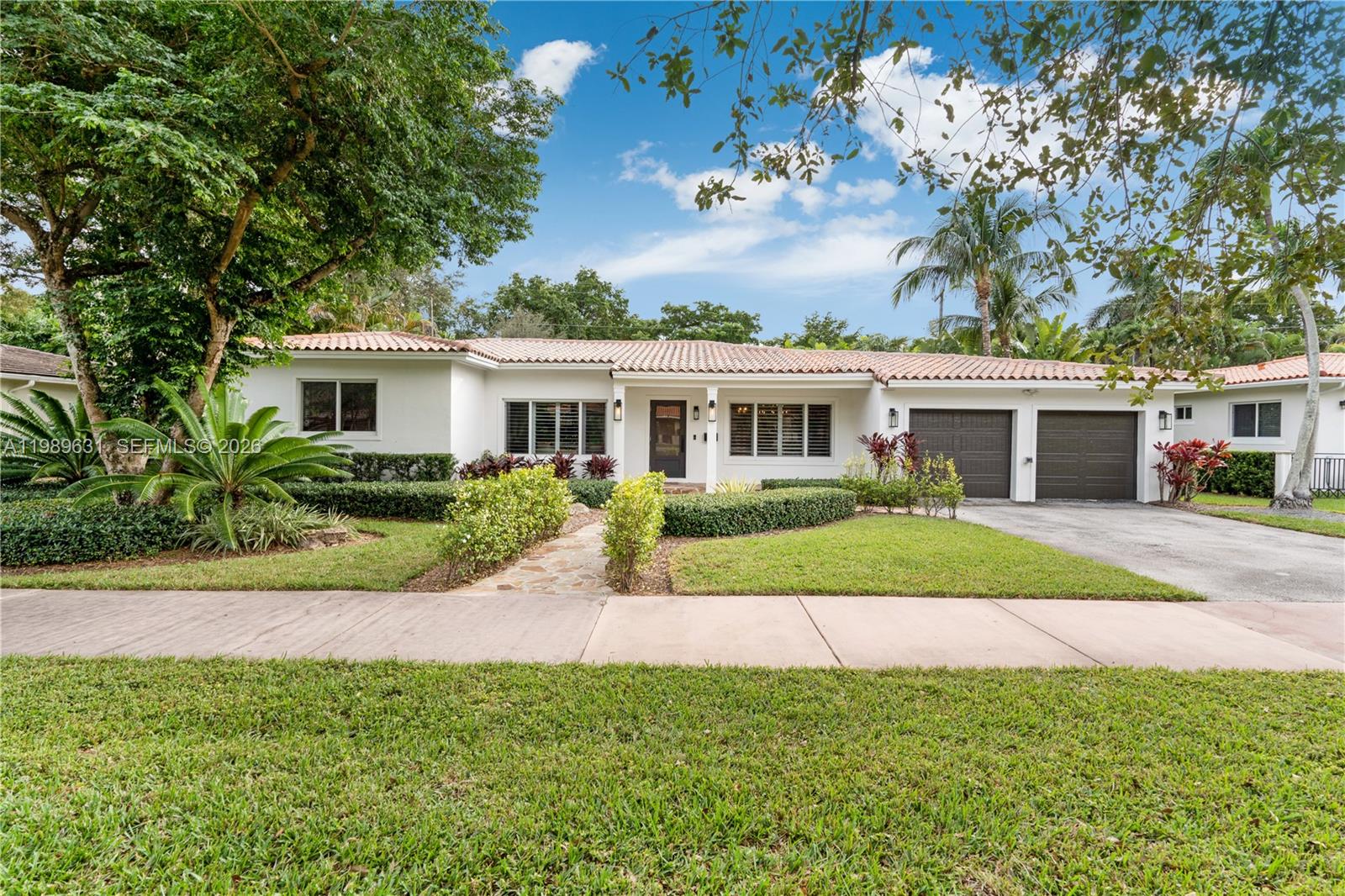 426 Hardee Road Coral Gables, FL 33146 - Photo 1 of 20 a front view of a house with a yard