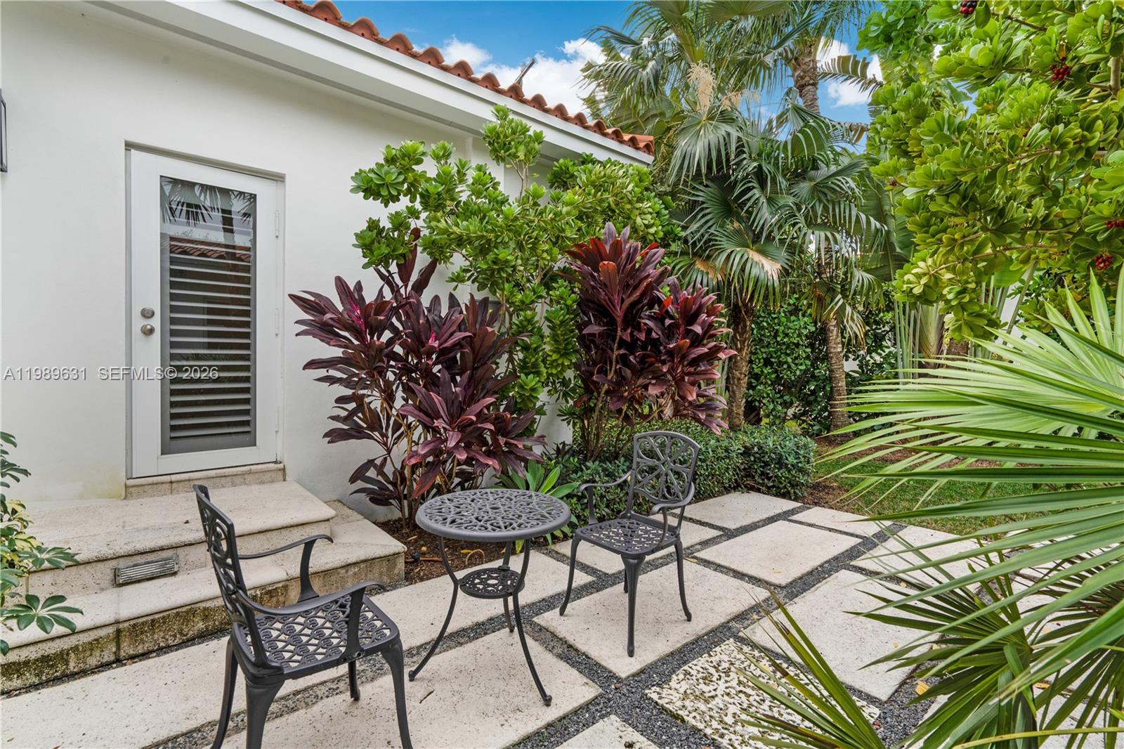 426 Hardee Road Coral Gables, FL 33146 - Photo 16 of 20 a backyard of a house with table and chairs