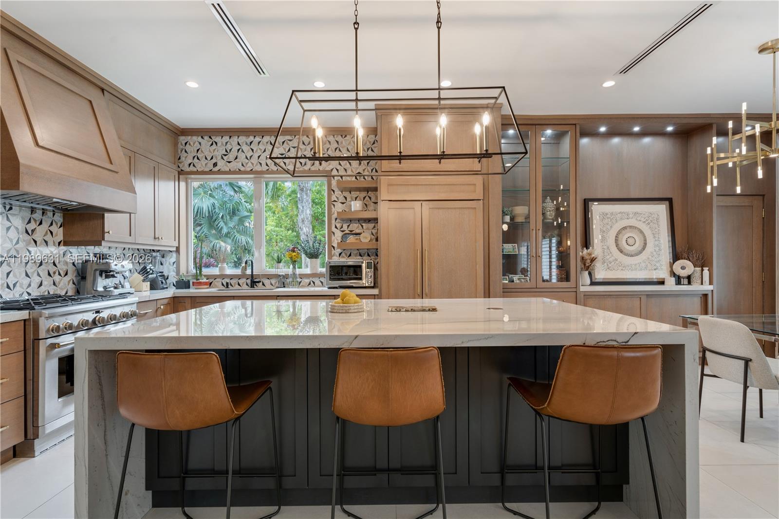 426 Hardee Road Coral Gables, FL 33146 - Photo 6 of 20 a kitchen with stainless steel appliances granite countertop a sink and chairs