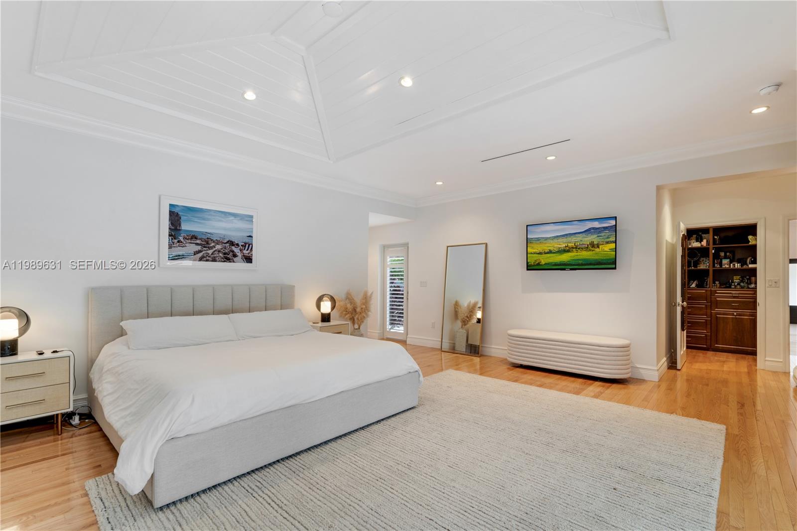 426 Hardee Road Coral Gables, FL 33146 - Photo 7 of 20 a bedroom with a large bed a painting on the wall and a couch