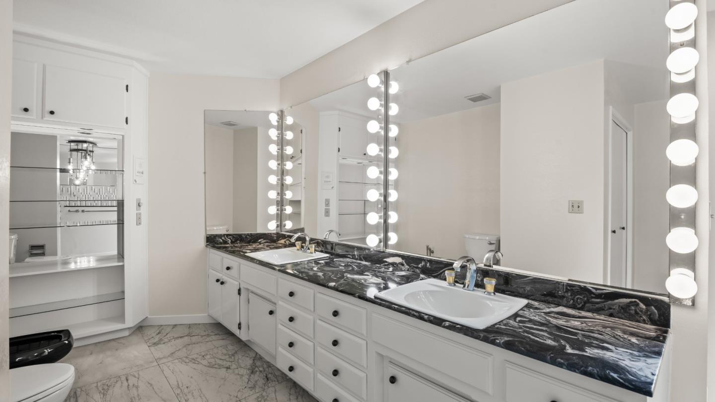 16353 Aztec Ridge Drive Los Gatos, CA 95030 - Photo 23 of 61 a bathroom with a granite countertop sink and a mirror