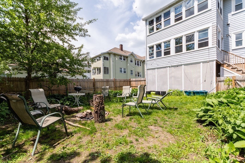 156-158 Trapelo Road Belmont, MA 02478 - Photo 18 of 20 a view of a chair and table in backyard of the house