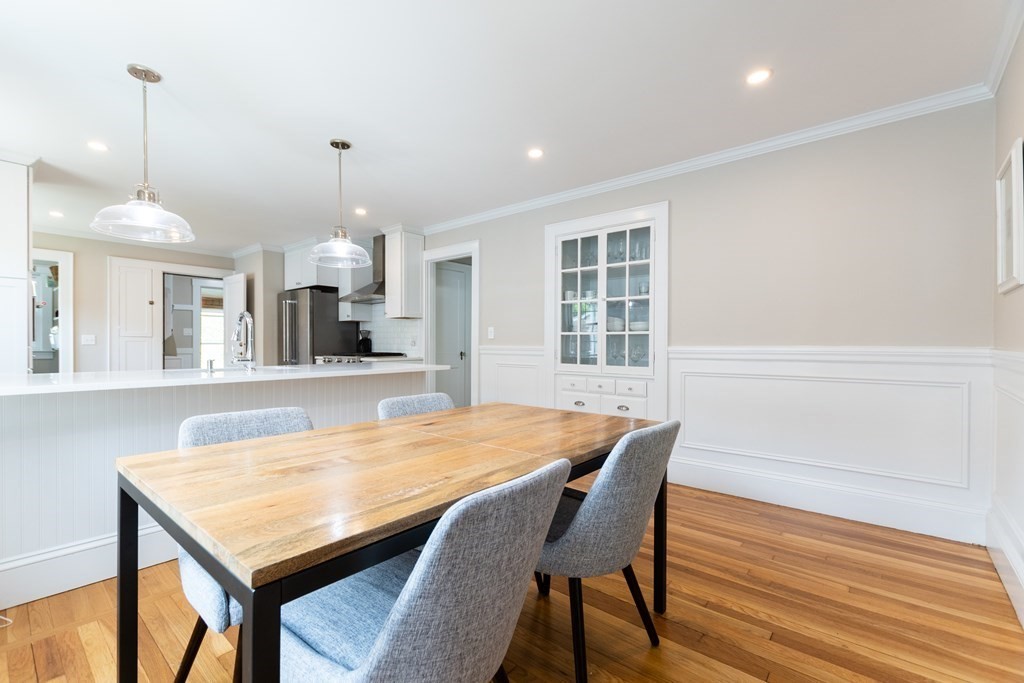156-158 Trapelo Road Belmont, MA 02478 - Photo 7 of 20 a dining hall with a dining table chairs with wooden floor and chandelier