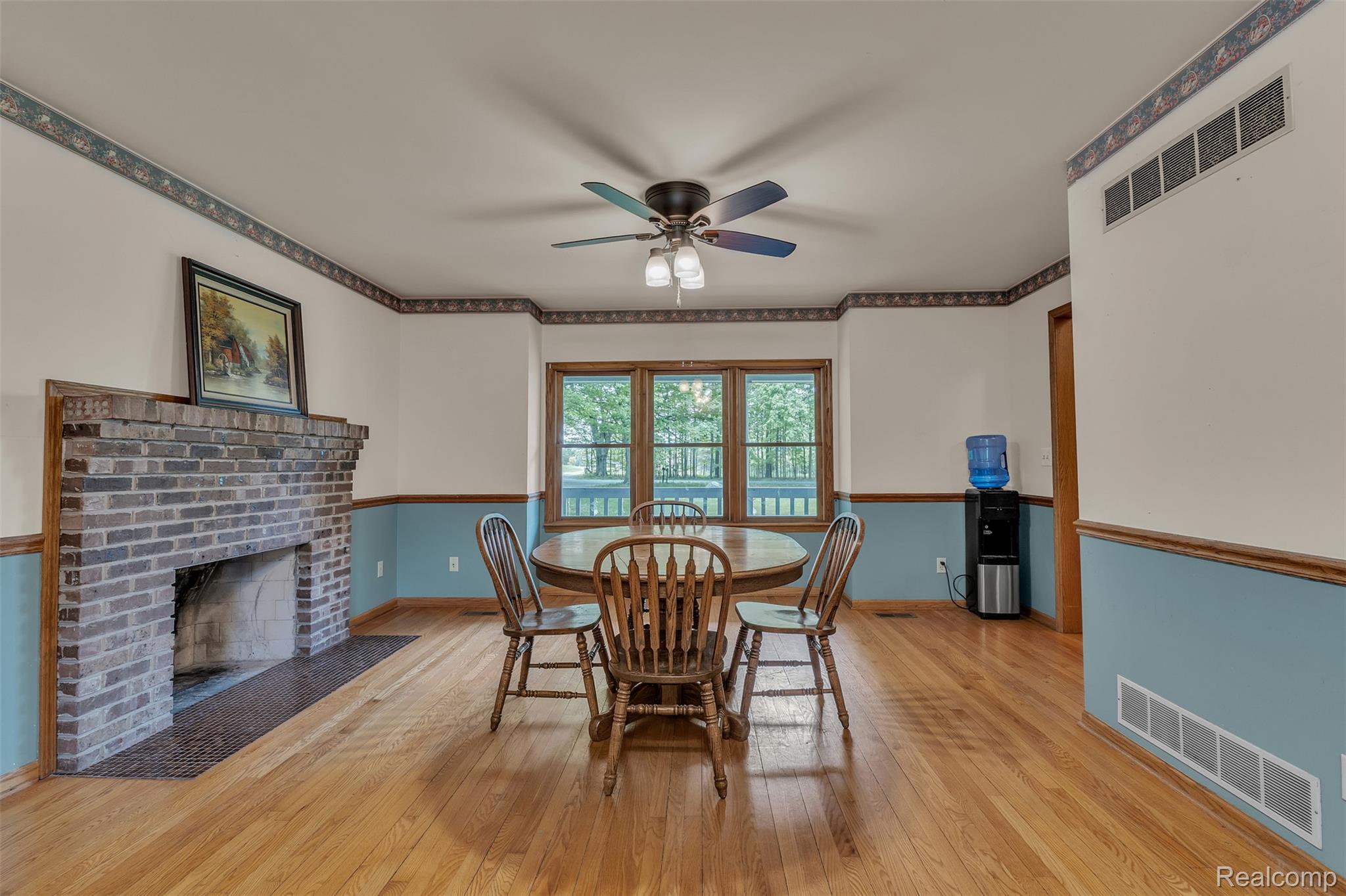 1345 Ives Road Mason, MI 48854 - Photo 14 of 92 Dining room with light wood-style flooring, a ceiling fan, and a brick fireplace