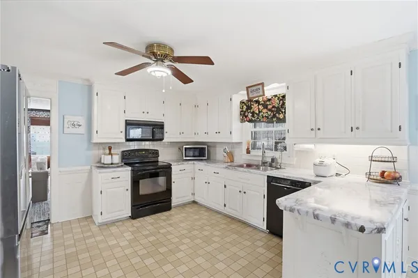 a kitchen with a sink cabinets and stainless steel appliances