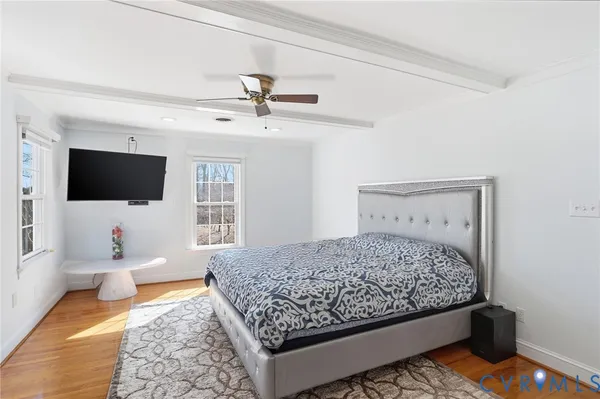 a bedroom with a bed and flat screen tv