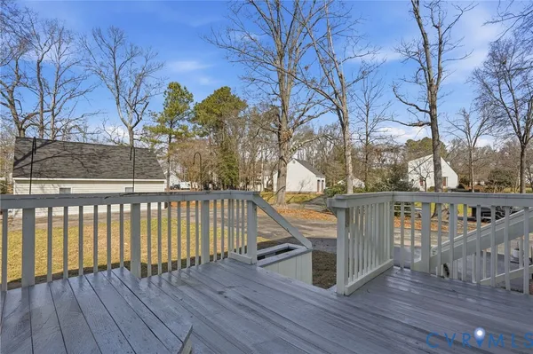a view of balcony with wooden floor and fence