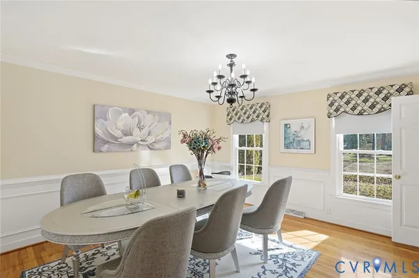 a dining room with furniture a rug and wooden floor