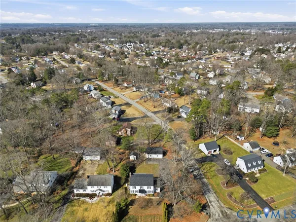 an aerial view of residential building with parking
