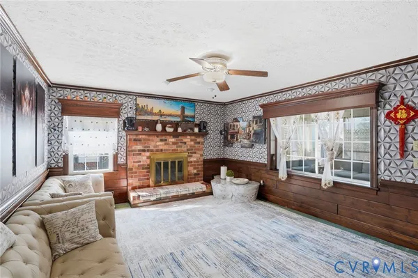 a living room with furniture large window and wooden floor