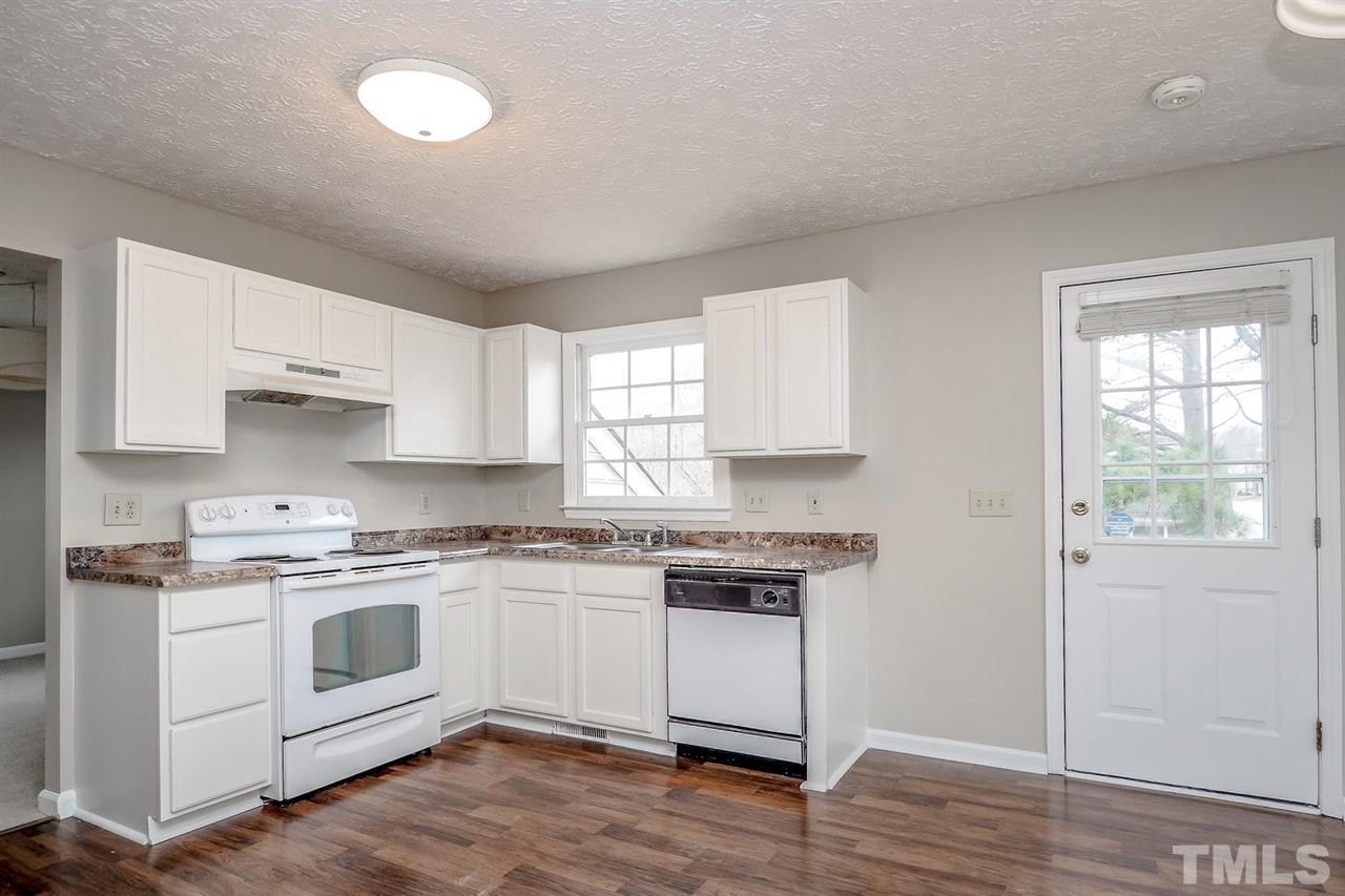 5333 Spring Pines Way Raleigh, NC 27616 - Photo 12 of 25 a kitchen with white cabinets stainless steel appliances and a window