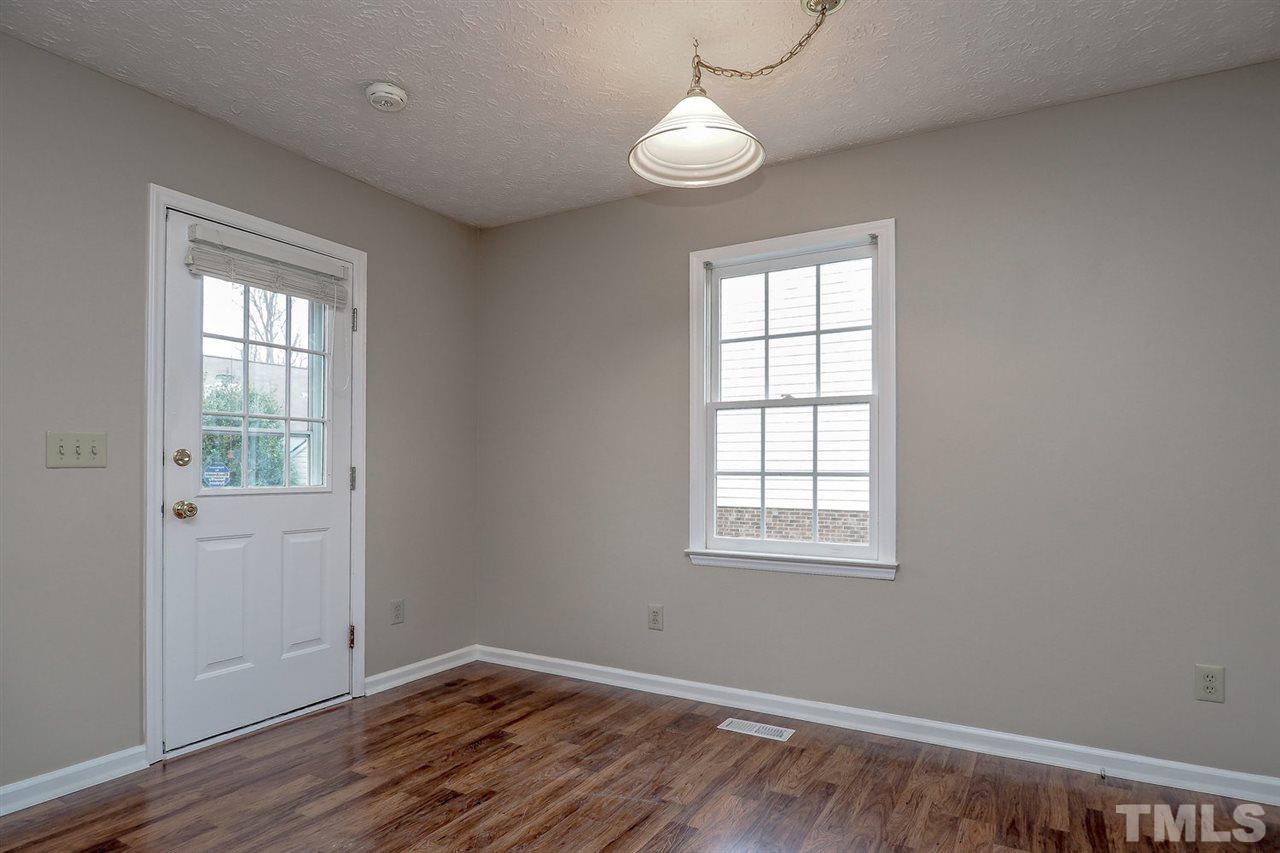 5333 Spring Pines Way Raleigh, NC 27616 - Photo 13 of 25 an empty room with wooden floor and windows