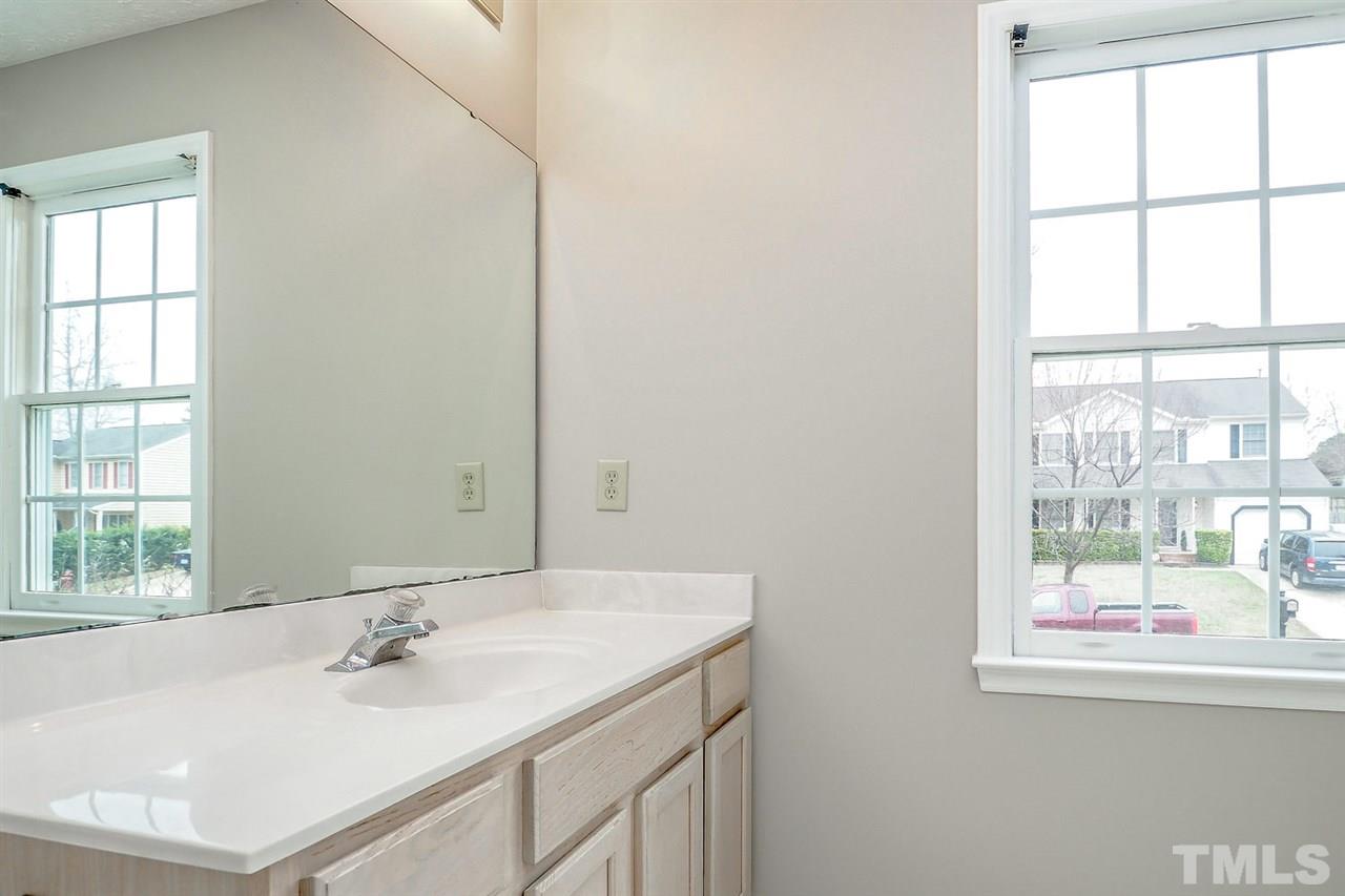 5333 Spring Pines Way Raleigh, NC 27616 - Photo 19 of 25 a bathroom with a sink and a mirror