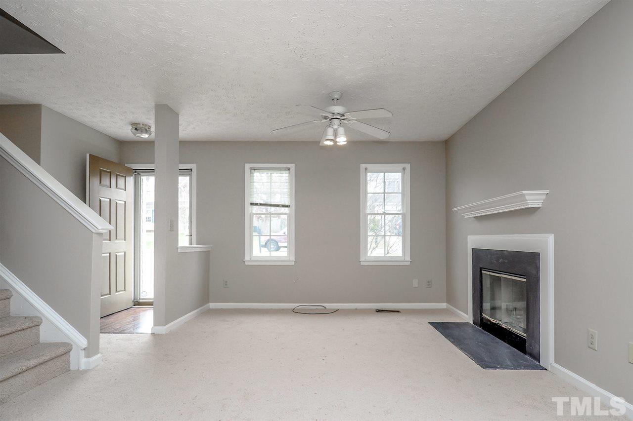 5333 Spring Pines Way Raleigh, NC 27616 - Photo 3 of 25 a view of an empty room with window and fireplace