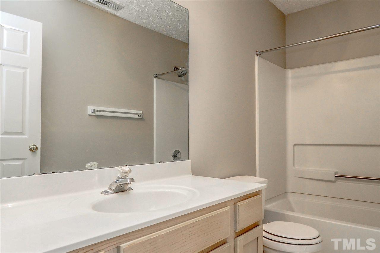 5333 Spring Pines Way Raleigh, NC 27616 - Photo 21 of 25 a bathroom with a sink toilet vanity and tub