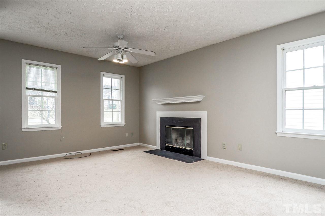 5333 Spring Pines Way Raleigh, NC 27616 - Photo 6 of 25 an empty room with chandelier fan and windows