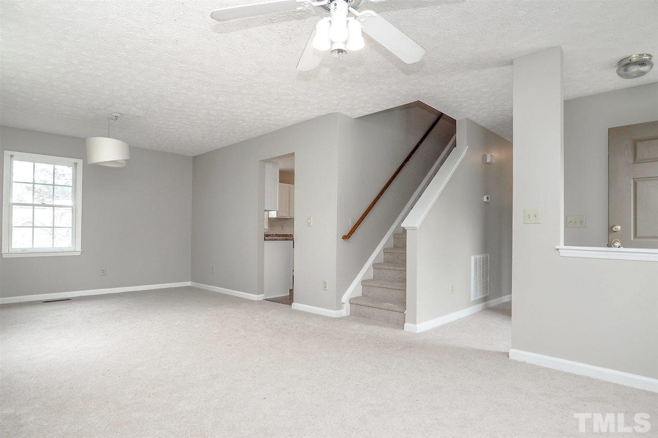 5333 Spring Pines Way Raleigh, NC 27616 - Photo 8 of 25 an empty room with windows and stairs