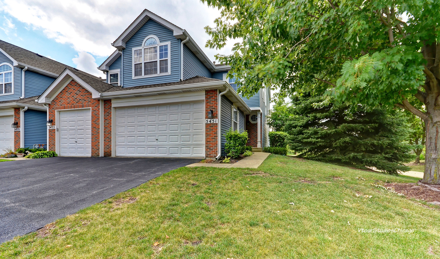 5451 Elizabeth Place Rolling Meadows, IL 60008 - Photo 1 of 34 a front view of a house with a yard and garage